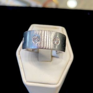 Diamond and 14 karat white gold men’s wedding band